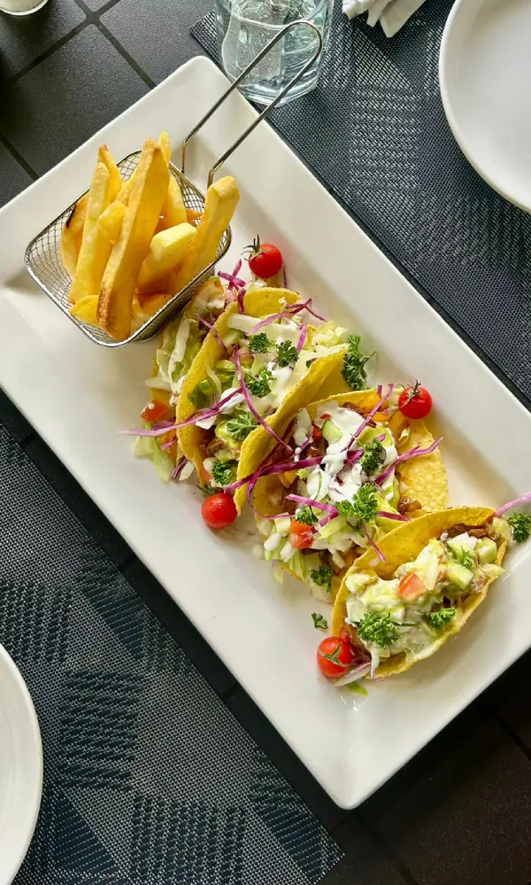 Fish tacos with fresh salad and crispy fries