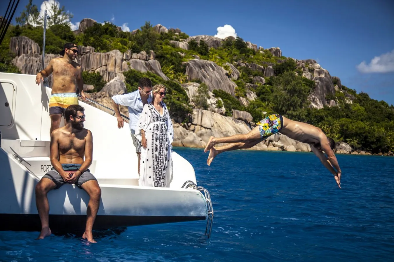 Guests diving off the catamaran