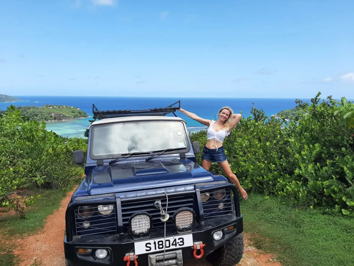 Posing by the 4x4 at a hilltop viewpoint