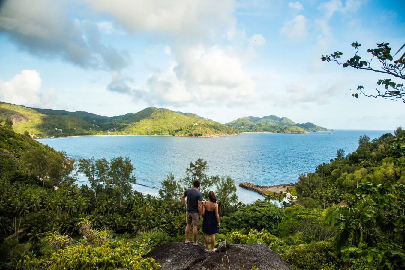 A couple taking in the view over a bay