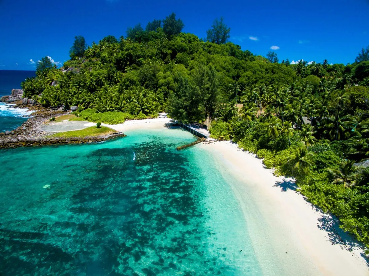Aerial view of a white beach and turquoise lagoon