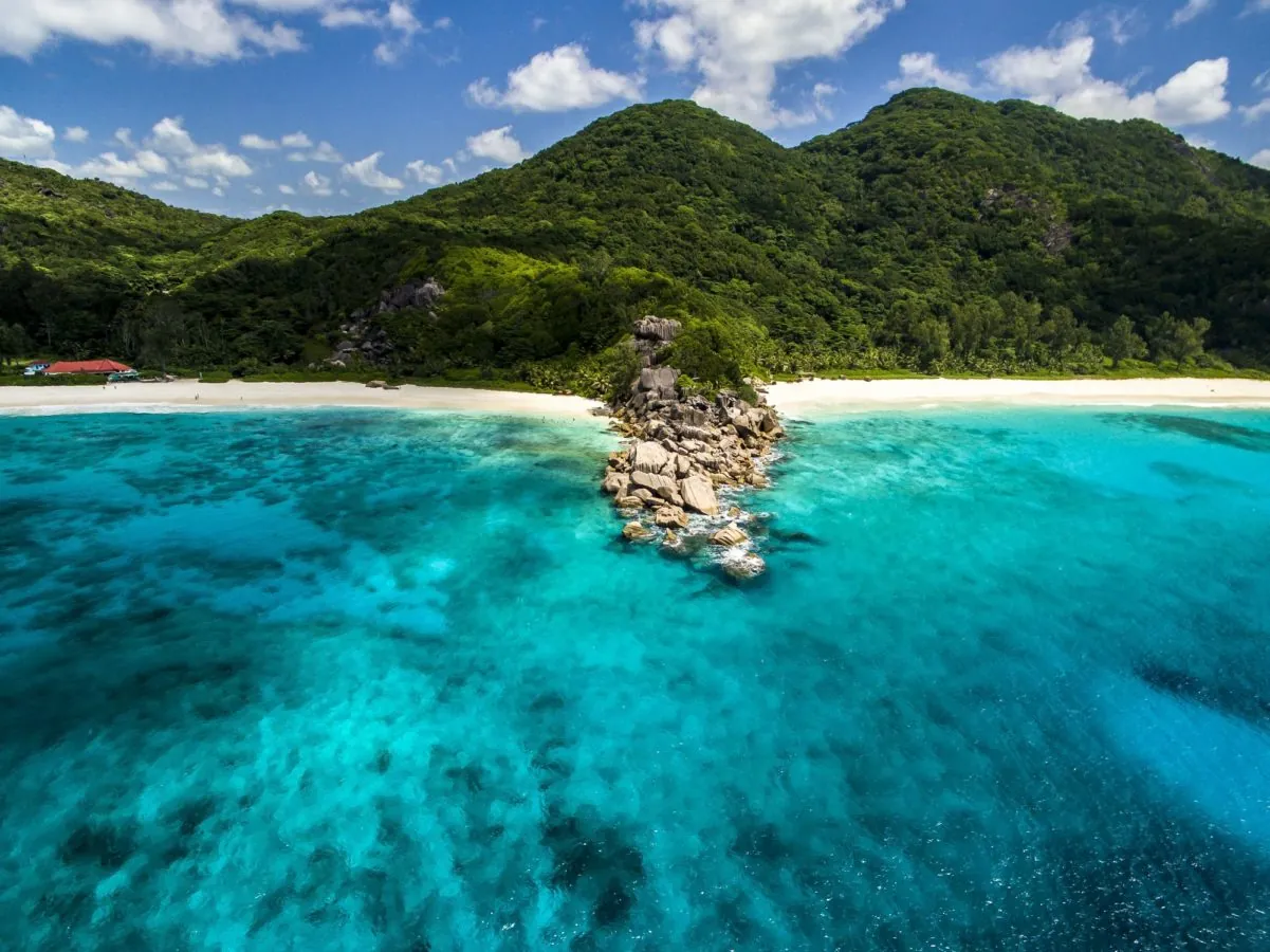 A turquoise bay and granite islet off La Digue