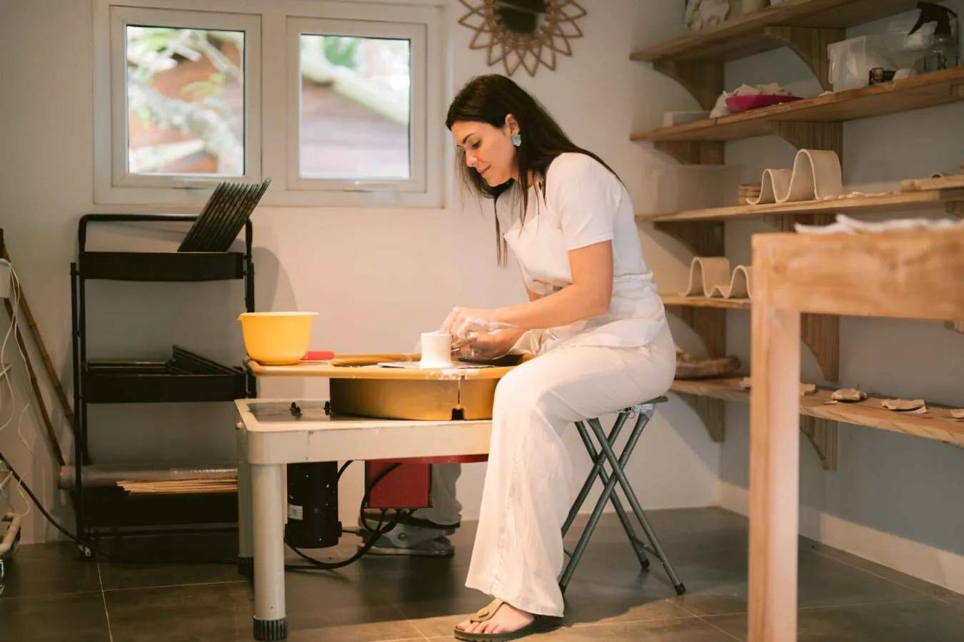 Working at the potter’s wheel in the studio