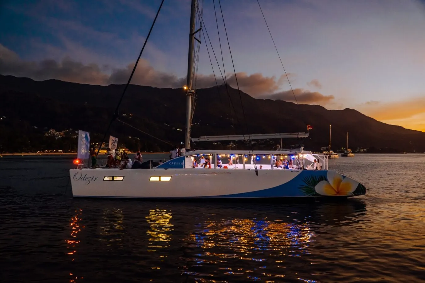 The catamaran lit up at dusk