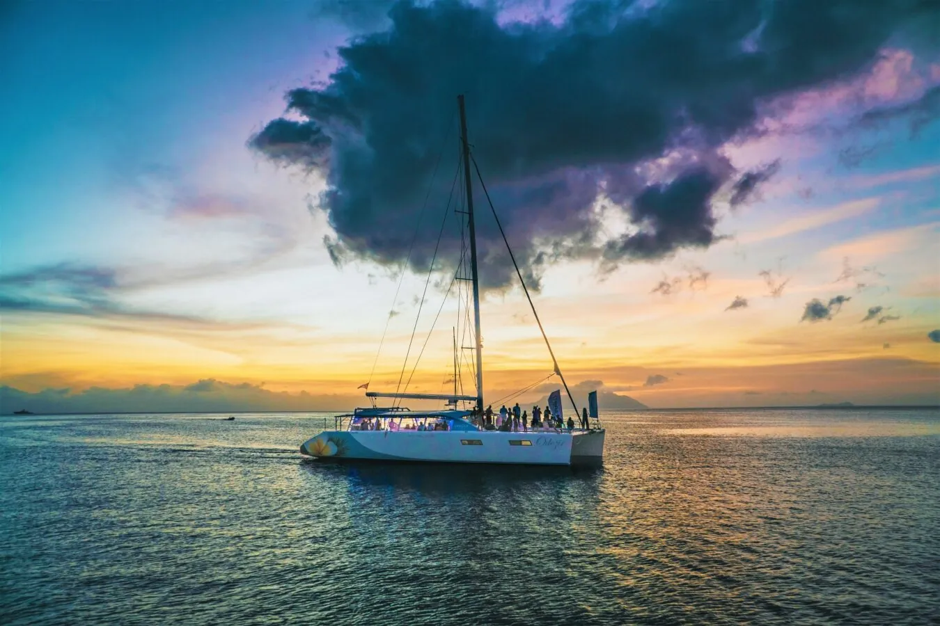 The catamaran under a colourful sunset sky