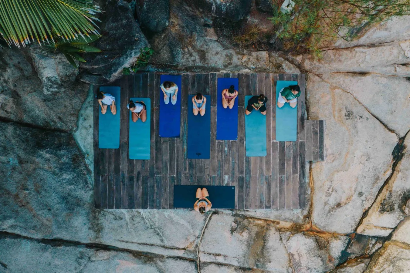 Aerial view of yoga mats laid out on a granite rock