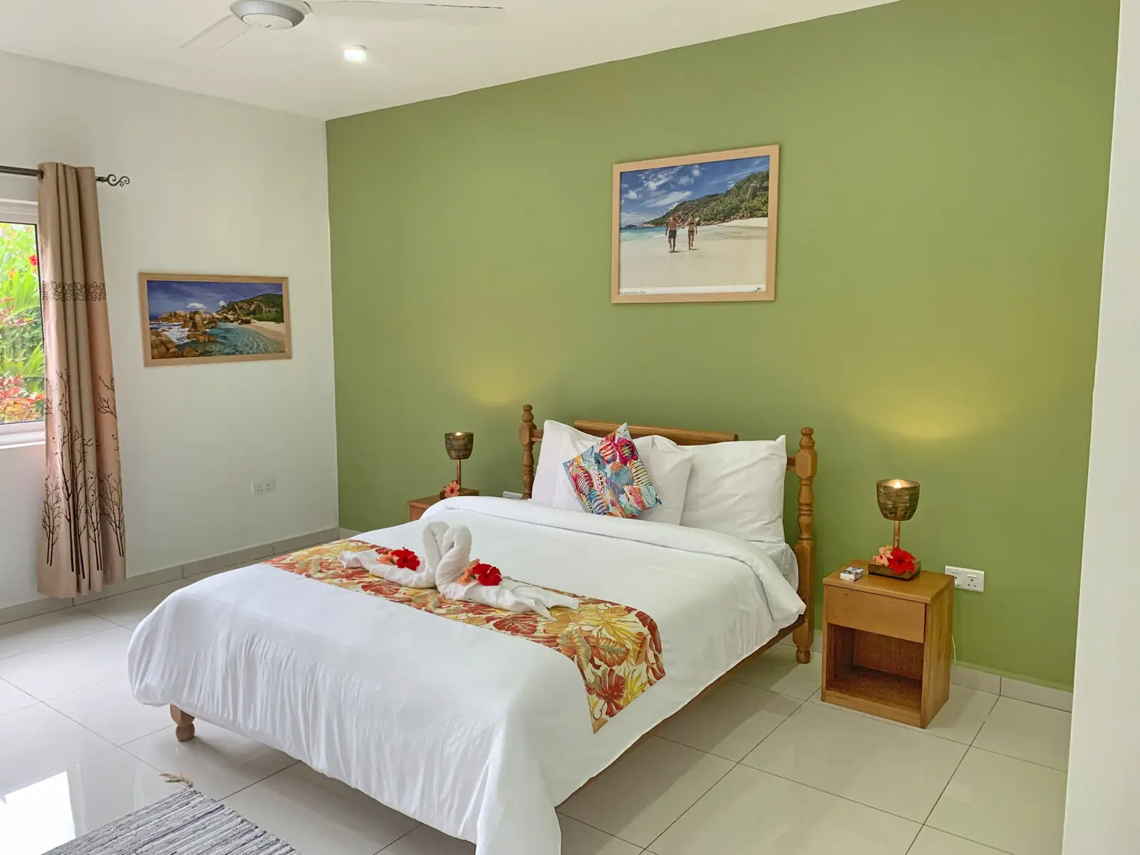 One Bedroom Apartment bedroom with sage walls and island artwork
