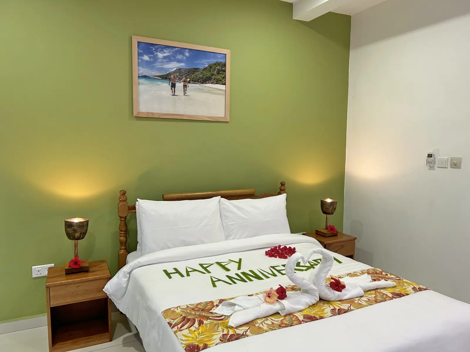 Bed dressed with towel art and flowers for a special occasion
