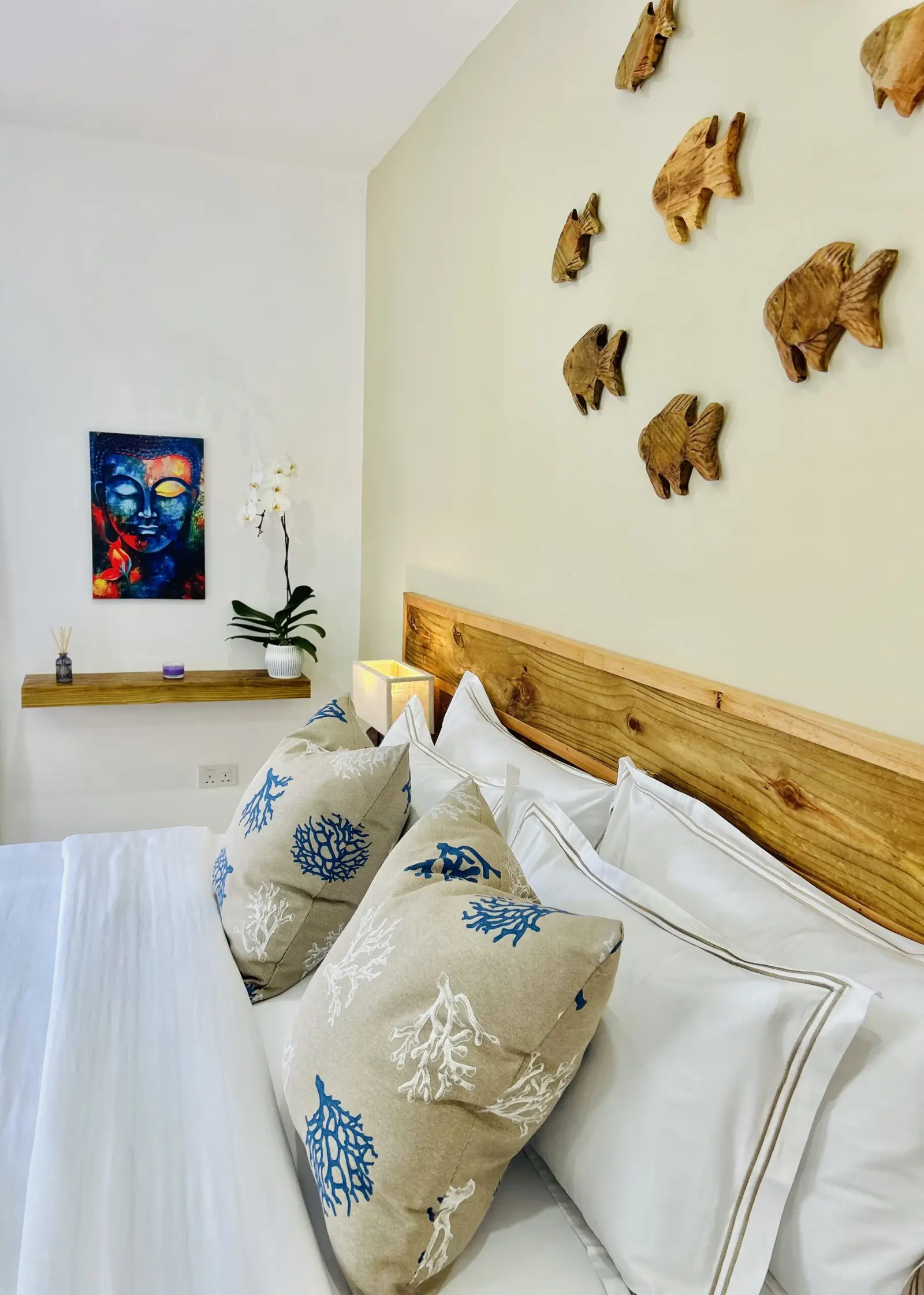 Soft cushions and orchid beside the bed