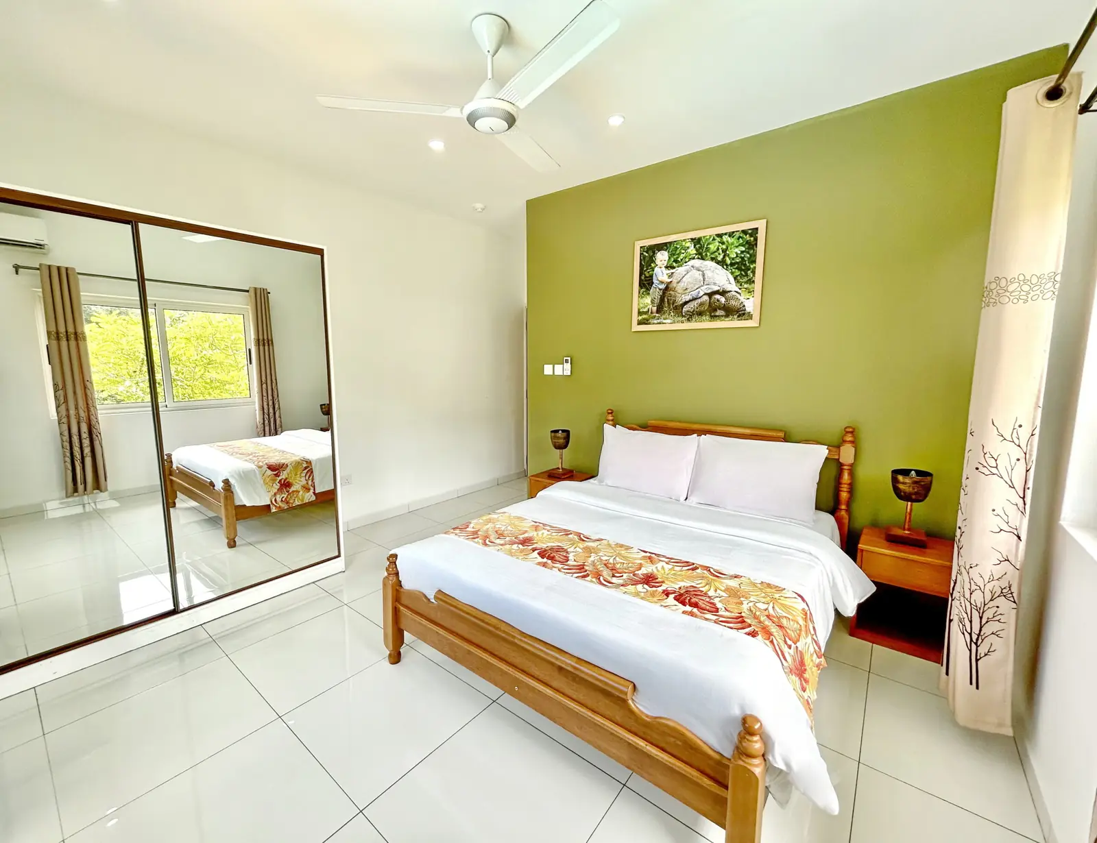 Two Bedroom Apartment bedroom with queen bed and mountain window